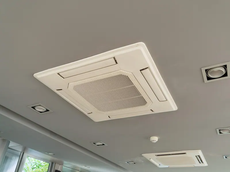 A ceiling cassette air conditioning unit in a commercial interior