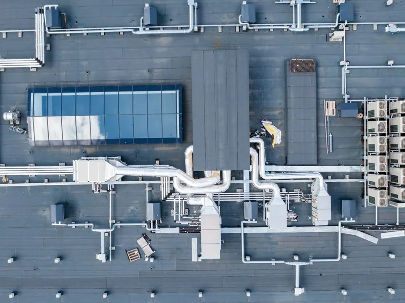 Aerial view of rooftop ductwork and condenser units on a commercial building